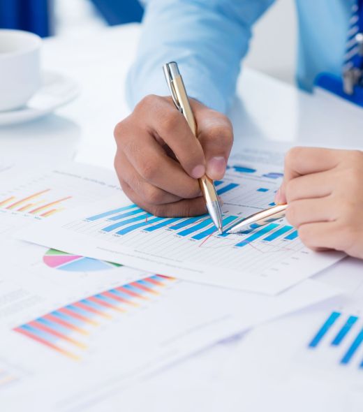 Cropped image of businesspeople analyzing financial graphs on the foreground